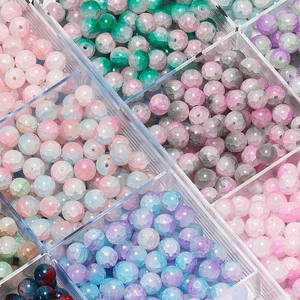 Macro shot of colorful 10mm cracked glass beads in storage box for jewelry making