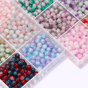 Macro detail of 10mm colorful cracked glass beads arranged in an acrylic organizer