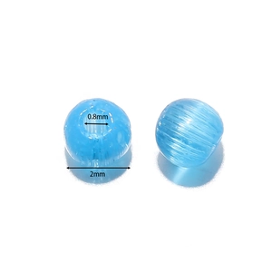 Macro detail of 2mm sky blue glass beads showing 0.8mm hole size for jewelry making