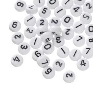 Flat lay of white acrylic round beads with black numbers 0-9 for DIY jewelry making