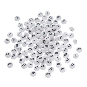 Detailed macro view of white acrylic round beads with black printed numbers and letters
