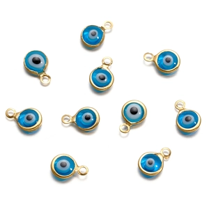 Detailed view of ten gold-edged blue evil eye charms for creative DIY jewelry making