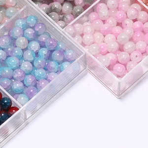 Close-up of 10mm crackle glass beads in multiple colors within a clear grid storage box