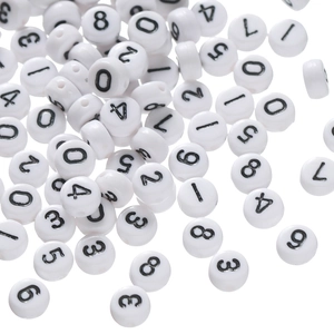 Macro shot of white acrylic round beads with black numbers for DIY jewelry making