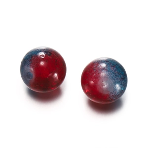 Macro detail of 10mm round glass beads with red and blue gradient crackle effect for DIY jewelry