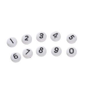Flat lay of white acrylic round beads with black numbers for DIY jewelry making