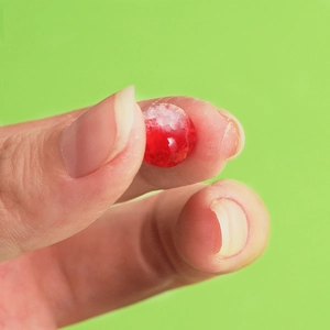 Close-up of 10mm red cracked glass bead with internal white ice fracture textures
