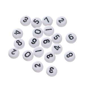 Flat lay of white acrylic round beads with black numbers for DIY jewelry making