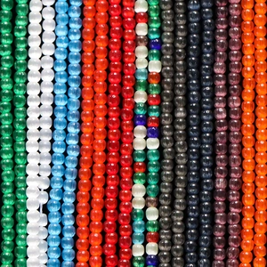 Macro shot of 2mm cat eye glass beads showing silk luster and vibrant multi-color texture