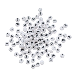 Flat lay of white acrylic beads with black numbers 0-9 for DIY jewelry making
