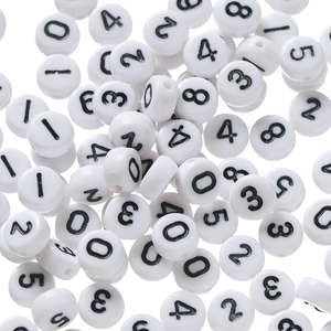 Detailed macro view of white acrylic round flat beads with black printed numbers for DIY