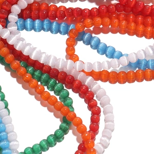 Close-up of 2mm colorful cat-eye glass beads with vibrant optical effects for DIY jewelry