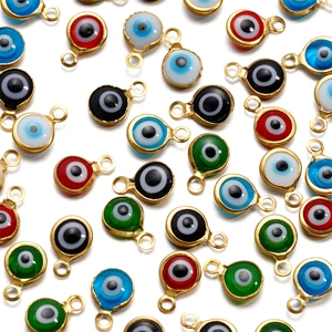 Macro detail of assorted colorful enamel evil eye connectors for DIY jewelry making