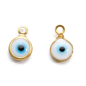 Detail of round golden evil eye connector charms with blue enamel for DIY jewelry