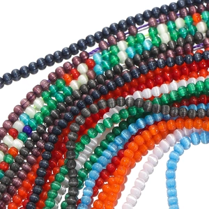 Macro detail of colorful cat-eye glass beads with optical chatoyancy for DIY jewelry
