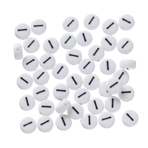 Macro view of white acrylic round flat beads with black minus symbol for DIY jewelry