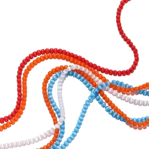 Macro shot of 2mm cat-eye glass beads in red orange white and blue for DIY jewelry