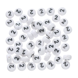Macro detail of white acrylic round beads with black number 2 for DIY jewelry making