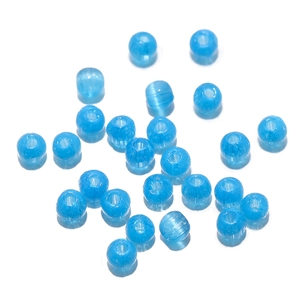 Macro shot of 2mm blue cat eye glass beads with drill holes for DIY jewelry making