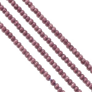 Macro shot of 2mm dark purple cat-eye glass beads for DIY jewelry making and crafts