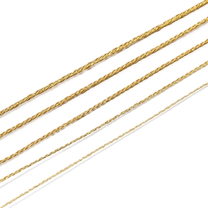 Macro shot of gold metallic twisted polyester threads in five different diameters for DIY