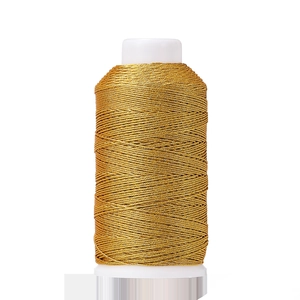 Macro shot of gold metallic polyester thread spool for DIY Chinese knot weaving