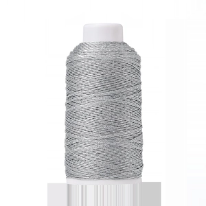 Macro detail of silver metallic polyester thread spool for DIY jewelry and knitting