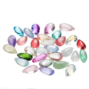 Macro view of multi-colored teardrop glass beads with top holes for jewelry making