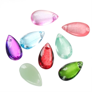 Macro detail of multi-colored teardrop glass beads with pre-drilled holes for DIY jewelry