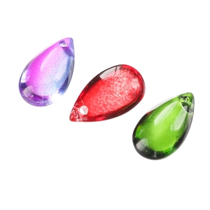 Macro shot of colorful water drop glass beads in purple, red and green for jewelry