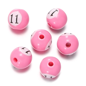 Detailed macro shot of pink acrylic beads with number 11 print for DIY jewelry crafts