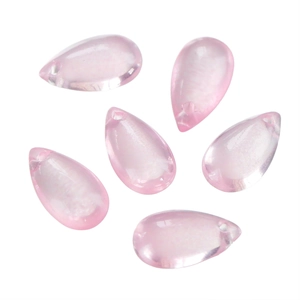 Detailed view of six pink translucent teardrop glass beads with pre-drilled holes for DIY jewelry