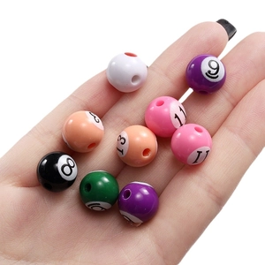 Close-up view of colorful acrylic billiard beads with printed numbers for DIY jewelry