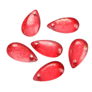 Macro detail of red teardrop glass beads with gold foil inclusions for DIY jewelry making