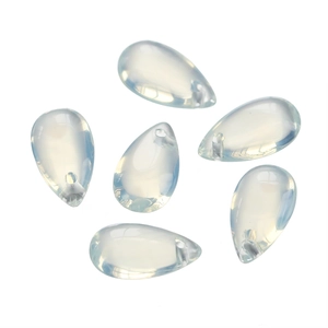 Macro detail of six opal glass teardrop charms with pre-drilled holes for DIY jewelry