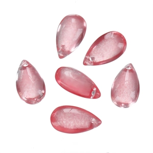 Detailed view of six pink teardrop glass beads with drill holes for DIY jewelry making