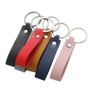 Detail view of colorful faux leather keychains with silver metal rings and rivets