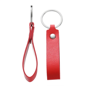 Detail of red lychee grain leather keychain with silver rivet and polished key ring