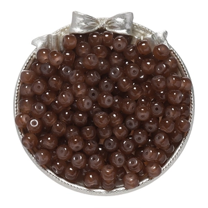 Macro shot of 8x7mm brown glass apple beads in a silver tray for DIY jewelry making