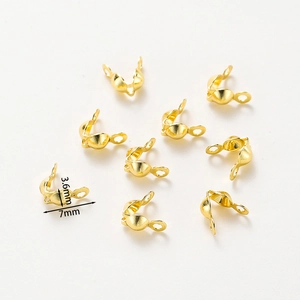 Macro detail of 7mm gold-plated fold-over jewelry connectors for DIY necklaces