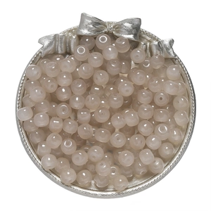 Macro shot of 8x7mm candy-colored glass apple beads in a vintage silver tray