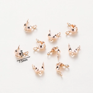 Macro shot of rose gold bead tips for jewelry making with 4mm and 7.5mm dimensions
