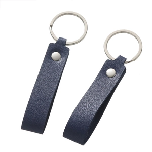 Detail shot of navy blue lychee textured leather keychains with silver rings