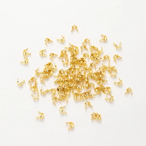 Close-up of gold-plated double bead tips for handmade jewelry connector endings