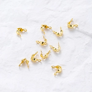 Macro detail of 18k rose gold plated ball chain connectors for DIY jewelry making