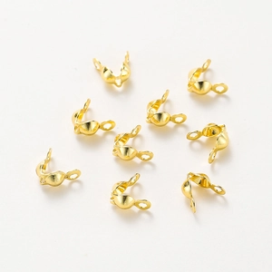 Macro view of gold-plated metal jewelry bead tips for DIY bracelet connecting