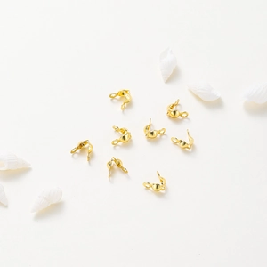 Macro detail of 18k rose gold plated double loops connectors and shell decoration