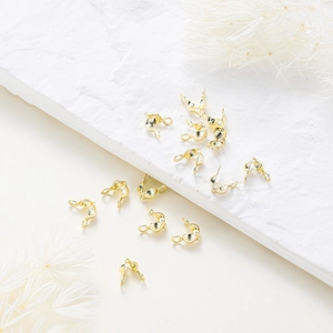 Detailed view of rose gold plated necklace clasp connectors on a textured white surface
