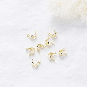 Close-up of 18k rose gold plated double fold bead tips for DIY jewelry making