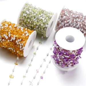 Detailed shot of mixed natural gravel stones and pearls on delicate DIY jewelry chains